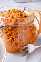Russian carrot salad with parsley in a preserving jar
