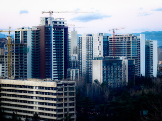 Evening scene with modern multistory buildings under construction.
