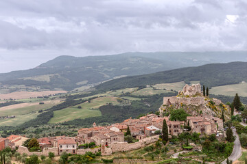 Fototapeta na wymiar View of the medieval town Castiglione d'Orcia with his ruined castle on the hill. Tuscany, Italy