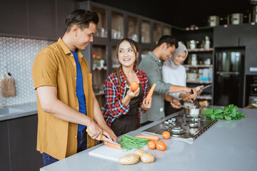 Shot of a group of friends cooking in the kitchen together