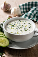 Bulgarian tarator sour milk soup in bowl on wooden table
