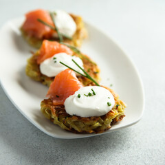 Homemade potato pancakes or lakes with salmon