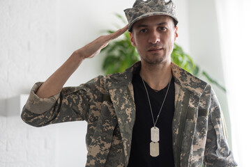 Photo of soldier in camouflaged uniform close-up view.