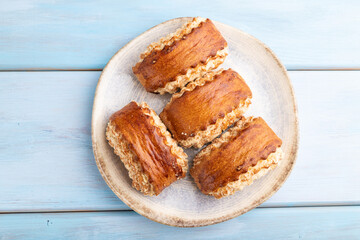 Traditional armenian dessert gata on a blue wooden background. top view, close up.