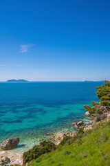 Fototapeta premium Sea wave and pebble. Summer vacation concept. Sea wave with foam incident on the coastal shingle. Travel concept