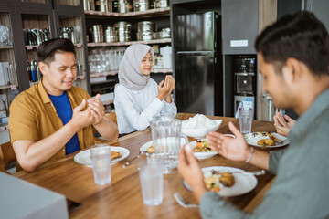 asian young people eating lunch together in the kitchen
