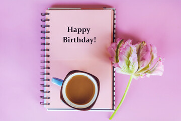 Happy birthday card with pink notebook and tulip flower 