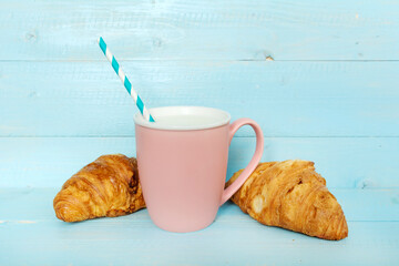 Cup of  Milk and Fresh Baked Croissants   on a Blue Wooden Background