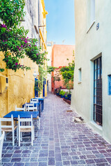 Street cafe in scenic picturesque streets of Chania venetian town with colorful old houses. Chania greek village in the morning. Chania, Crete island, Greece