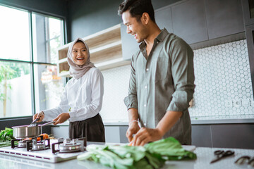 romantic young muslim couple have fun making food at home
