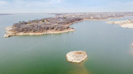 Grapevine Lake with small island and wealthy residential neighborhood in background near Dallas,...
