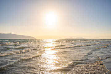 Obraz premium The concept of summer holidays. A sea wave with foam falls on the sand. Travel concept