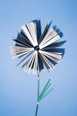 Old books and pencils on bright blue background. Education, knowledge or Nature concept. Flat lay.