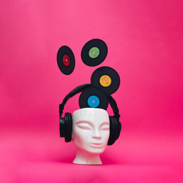 Head with headphones and Vinyl Records. Old-fashioned, surreal, retro music concept. Spring and Summer mood. Conceptual, contemporary art. Vintage styled, idea, aspiration, comparison of eras.