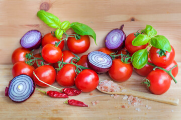 Ingredients for Arrabiata Sause .Cherry Tomatoes, Red Onion ,Chili peppers   and Basil on a Wooden Background 