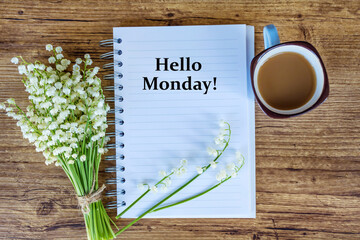 Notebook with Hello Monday Message , Bouquet of Lily of the Valley  and Cup of Coffee .Spring...