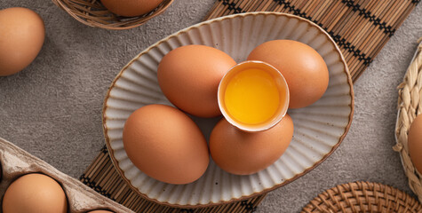 Fresh brown chicken eggs in a plate.