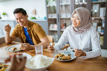 asian young people eating lunch together in the kitchen