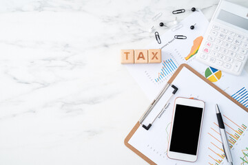 Concept of calculating and paying tax with smart phone on white table.