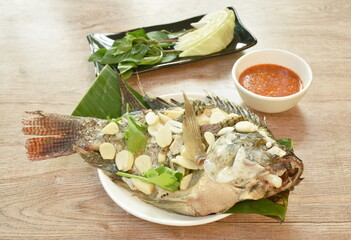 steamed mango fish with vegetable dipping spicy sauce on plate