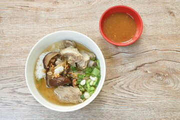 boiled rice with pork bone and slice black mushroom in soup on bowl