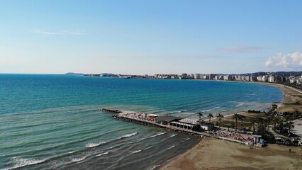 Fototapeta na wymiar Drone Shot of the Beach in a Bright Day with Palm Trees and Blue Water