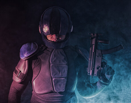 Cyberpunk concept, future world. Police officer cop in dark, halfman bionic cyborg or reloads gun, twitches cocking lever, Stands looks at camera in dark. Science fiction scene, fantasy, sci.