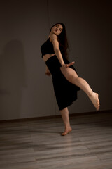 Fototapeta na wymiar Slender flexible dance performer during a dance practice in modern studio
