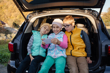 Group of kids taking selfies with smartphone