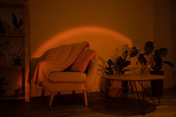 Home interiour, cozy chair with pillows at sunset