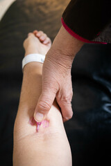 Vertical picture of an arm with a iv drip to draw blood and administrate some liquid medicines