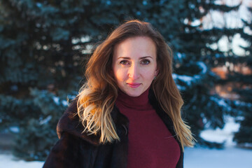 Portrait of a happy adult woman outdoors in winter