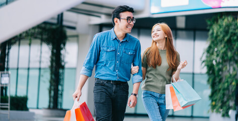 Asian couple shopping at the mall