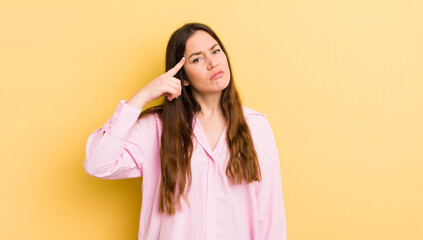 pretty caucasian woman feeling confused and puzzled, showing you are insane, crazy or out of your...