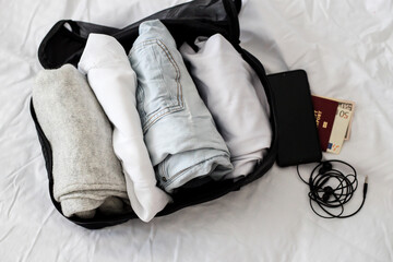 Packing clothes, documents into the suitcase. Travel concept, packing up before departure. emigration. Preparing for travel, going on vacation, break, rest. Business trip.