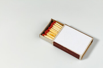 Close-up Matchbox with red matches on white background, selective focus. place for text. international match day