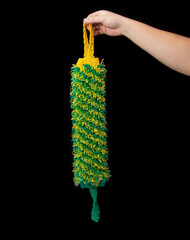 Rigid body washcloth in hand on black background, isolate. Close-up, scrubber