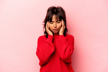 Young hispanic woman isolated on pink background having a head ache, touching front of the face.