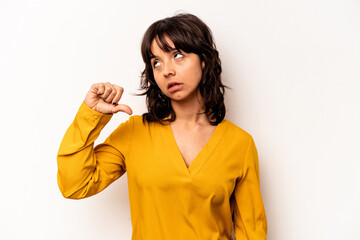 Young hispanic woman isolated on white background showing a dislike gesture, thumbs down....