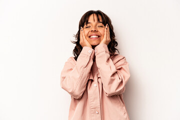 Young hispanic woman isolated on white background laughs joyfully keeping hands on head. Happiness concept.