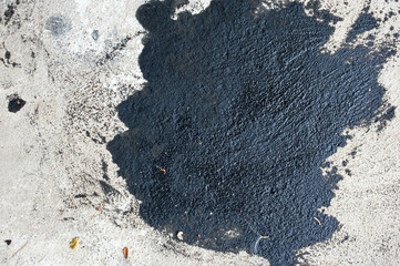 Stain of engine oil dripping onto the floor.