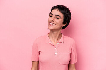 Young caucasian woman isolated on pink background relaxed and happy laughing, neck stretched showing teeth.