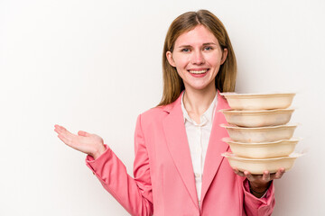 Young business English woman holding tupperware of food isolated on white background showing a copy...