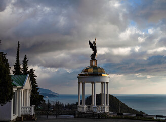 Fototapeta premium Arbor with an angel on the background of the sea