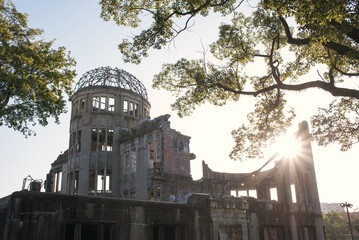 Silhouette of Atomic Bomb Dome backlit by sunlight in Hiroshima,...