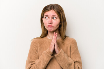 Young russian woman isolated on white background praying, showing devotion, religious person...