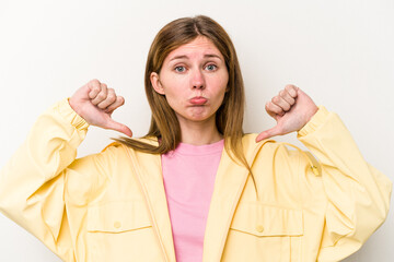Young English woman isolated on white background showing a dislike gesture, thumbs down....