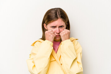 Young English woman isolated on white background throwing a punch, anger, fighting due to an...