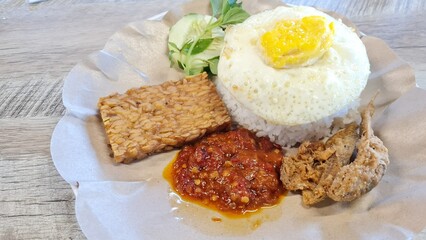 Onion Sambal or Spicy Onion Sauce with ingredients, Shallots, Red Chili, Garlic, and Salt as a companion to eat rice, tempeh omelette and salted fish