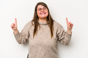 Young caucasian overweight woman isolated on white background indicates with both fore fingers up...